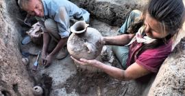 Image: ISAC archaeologists work on an archaeological site to excavate a pot.
