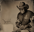Ron Vasser, a cowboy who has been involved with horses on the competitive level for over twenty years poses with a bronze horse bit from Persia dating to 550–330 BC. OIM A22945