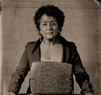 Portrait of real estate broker Margie Smigel with the Chicago Stone, a record of land transfers from 2600 BC.