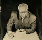 Norm Bobins, the retired chairman of the board, president, and CEO of the LaSalle National Bank is shown with the earliest accounting records in the world – clay balls that enclose small tokens that probably acted as receipts for deliveries. The clay balls are from Iran. They date to about 3400–3100 BC. OIM A32567, A64606