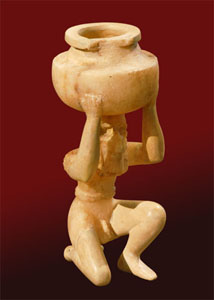Statuette of kneeling nude male figure holding vessel, alabaster, from Shara Temple at Tell Agrab (date: ca. 2600 B.C.). Oriental Institute Museum.